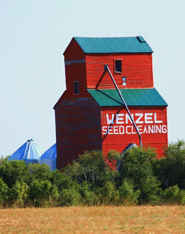 Red grain elevator on a farm south of Leader